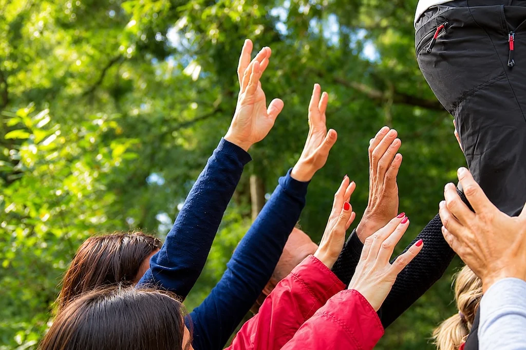 Hands raised in celebration outdoors