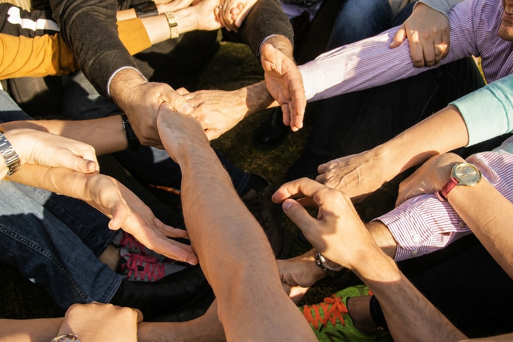 Participants joining hands in a circle