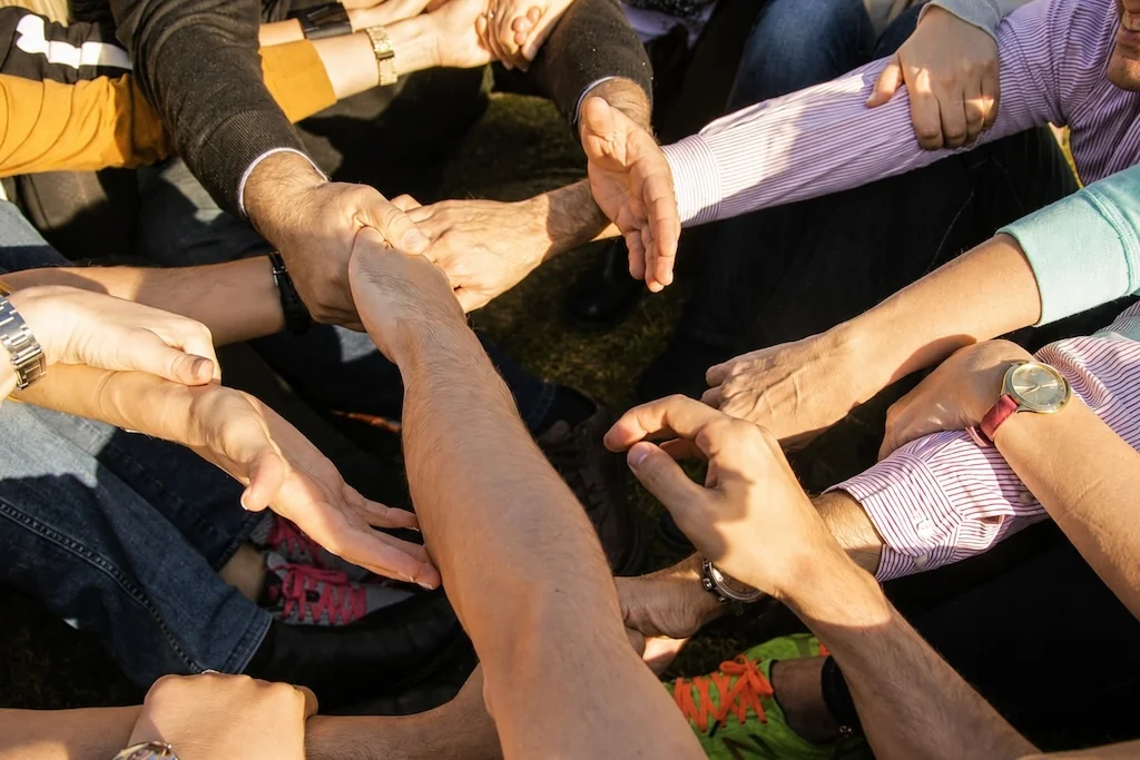 Participants joining hands in a circle